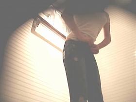 Sexy dressing room girl is trying on skin tight jeans