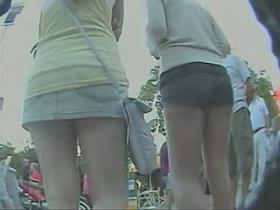 Couple of smokin brunettes in an upskirt public square ass video