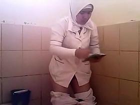 Arab woman goes pee in a public toilet