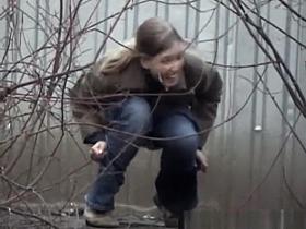 Woman pees beyond shelter