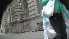 Brunette in tight pants followed by a candid cam voyeur