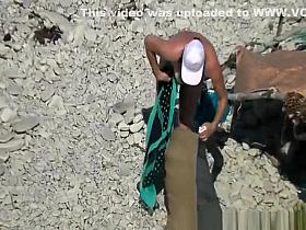 Nudist woman spied in beach sunbathing