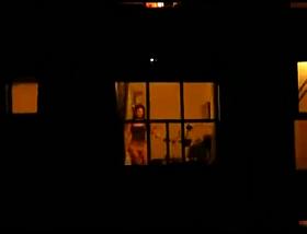 Hot Babe teases her neighbours at the window