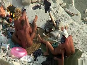 Two nudist couples in beach