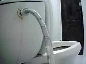 Woman takes a piss in toilet