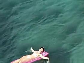 Nude women in rocky beach