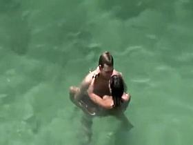 Group of nudists sunbathing in the beach