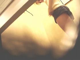 Girl in a dressing room puts on tiny top and candid shorts