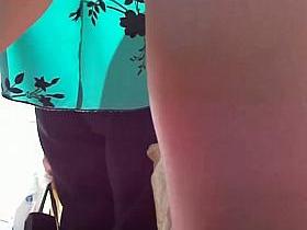 Smooth legs with a sexy tattoo in this street upskirt video