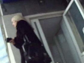 European woman is black stockings is standing while we watch her ass