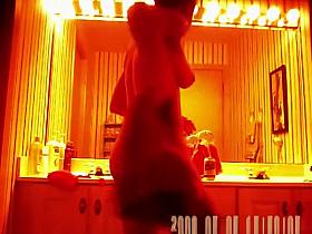 Woman spied changing in bathroom