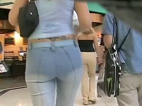 Hot asses in denim wiggling around the street candid video