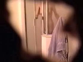 Shower spy cam gets mature and hot brunette