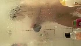 Guy in bathtub films wife showering