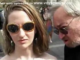 Cute naked chick in a public square