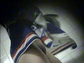 A spy cam in the swimming pool changing room presents a hot sexy woman