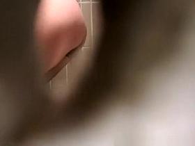 Woman takes a pee in public toilet