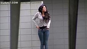 Desperate chick wetting her jeans on the street