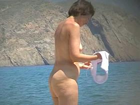 Hot mature beach nudist strips of her clothes and gets wet