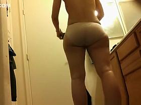 Asian spied dressing in bathroom