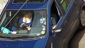 Looking into the neckline of a busty girl in the car