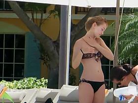 Teen rubs herself with lotion by the pool