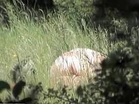 Naked brunette enjoying voyeur sex in the open air