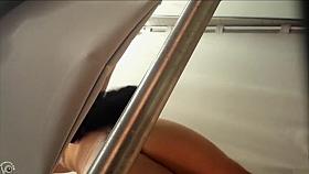 Changing room cam shows a woman trying on dresses