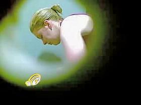 Mature fem spied toweling through dressing room wall hole