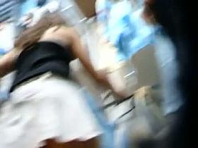 Cute brunette chick in short skirt gives hot upskirt at the mall