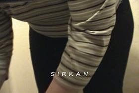 A fat woman sitting on the toilet while being filmed