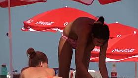 Busty girl shows her mighty jugs on a nudist beach