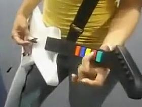A big boobed guitar hero player