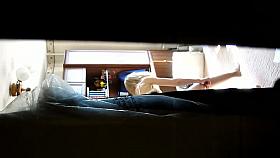 Voyeur films a hot blonde girl behind the door