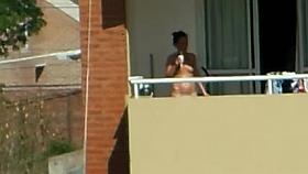 girl sunbathing topples un bacony in argentina.