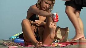 Shiny black bikini on a sweetie at the beach