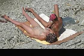 Nude woman grabs man's cock