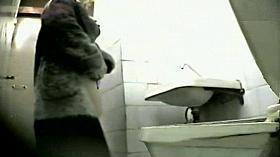 Amateur girls lift up coats and sit pissing on toilet