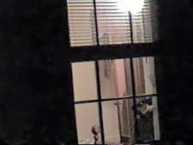 Naked bimbo is dancing and getting spied thru window