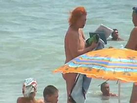 Buxom nude beach babes flaunt their jugs before a hidden camera