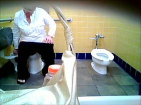 older woman in white with glasses