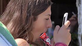 Teen girl sucks on an ice cone