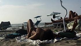 Adorable topless girl with big boobs enjoys the sun