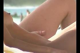 Beach voyeur video of a nude milf and a nude Asian hottie