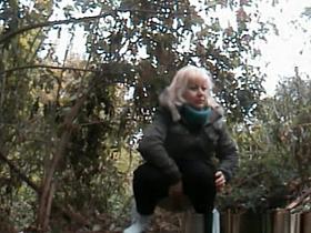 Mature blonde woman pissing