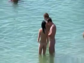 Brunette nudist woman with round tits in the beach