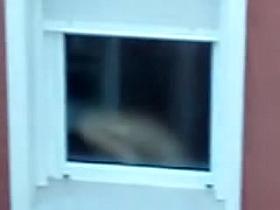 Nude titted female is seen on window voyeur video