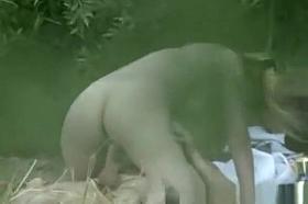 Voyeur hidden in the bushes secretly spies naked couple