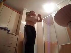 Hot busty woman undressing before shower