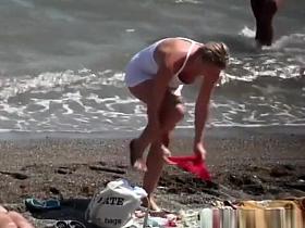 Nudist blonde woman caught in nudist beach